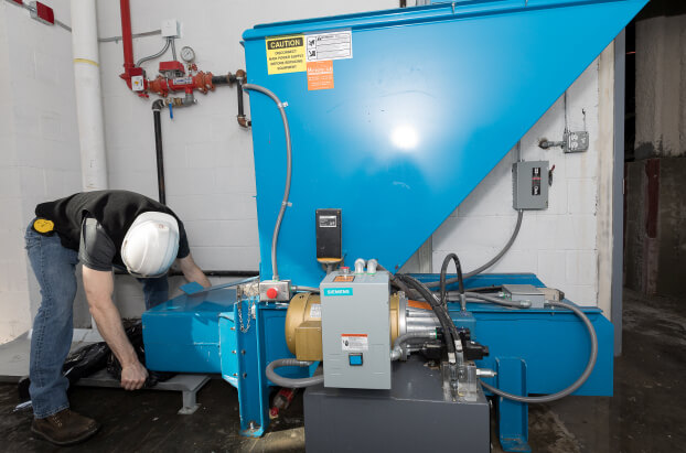 Metropolitan Engineer Demonstrates Replacing a Bag on a Bag Compactor